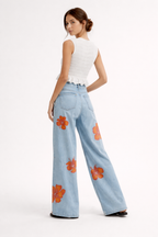 Pantalon denim jambe large grandes fleurs imprimées - Colette